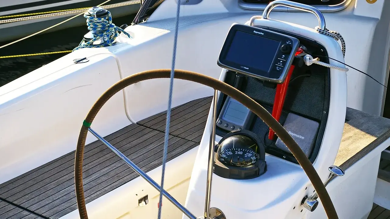 Timone, bussola e GPS su una barca a vela. Il timoniere, chi guida la barca, si affida a questi strumenti per la navigazione.