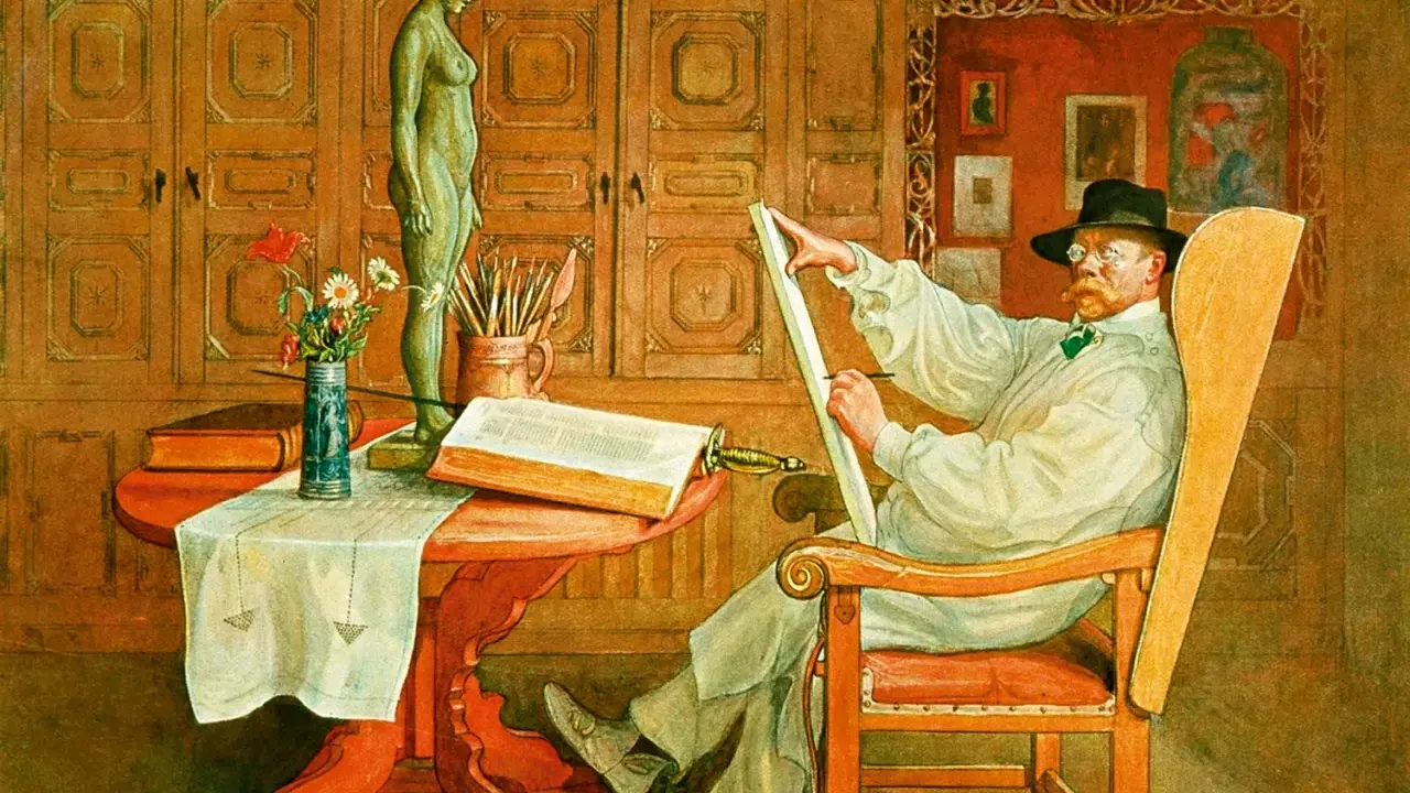 Carl Larsson sitter i en stol och ritar på en duk. Framför honom står en statyett, en bok och en vas med blommor.