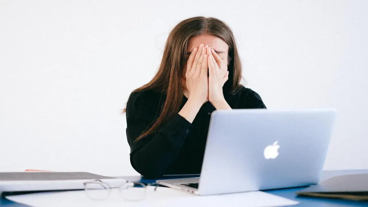 Donna disperata davanti al PC, vittima di un reato revenge porn.