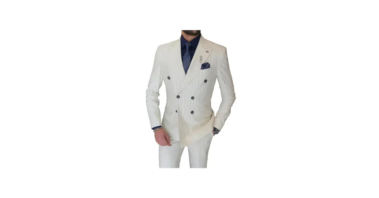 A man models a sharp double-breasted suit in white with subtle pinstripes. He wears a navy shirt and patterned tie, completing the sophisticated look.