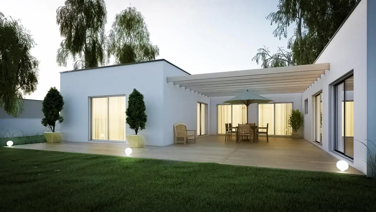 Une terrasse moderne avec mobilier de jardin et pergola, entourée d'un jardin verdoyant et d'arbres. Une extension de maison qui invite à la détente, parmi les plus belles extensions de maison.