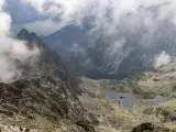 Widok na szlak turystyczny i jeziora w Tatrach, w oddali majaczy schronisko pod Rysami.