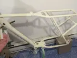 Nyligen sprayad cykelram i en ljusgul nyans, redo för nya äventyr.