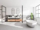 Salle de bain moderne avec baignoire îlot, double vasque et douche. Le sol en béton ciré, un carrelage sans joint, crée une ambiance épurée et contemporaine.