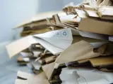 Stos papierowych odpadów, w tym kartony i opakowania, oznaczony jako kod odpadu 15 01 01.