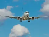 Samolot pasażerski z wysuniętym podwoziem zbliża się do lądowania, idealny na city break z Krakowa.