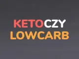 Napis KETO CZY LOW CARB w kolorach czerwonym, białym i pomarańczowym na ciemnym tle.