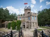 Kamienny zamek z polską flagą, otoczony lasem. Czy to właśnie tutaj jest Podlasie?