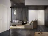 Interni moderni con infissi marroni e porte bianche. Un salotto accogliente con divani grigi, tappeto beige e un'elegante lampada a sospensione.