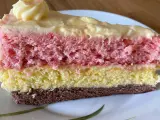 Ein Stück bunte, einfache Torte mit Puddingcreme. Schichten aus Schoko-, gelbem und rosa Biskuit, bedeckt mit cremiger Puddingfüllung.