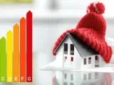 Model domu w czapce symbolizuje efektywne do ocieplania budynków. Obok wykres efektywności energetycznej.