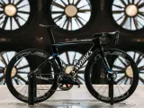 A black S-Works aero bike, designed for speed, is showcased in front of large industrial fans. This is what an aero bike looks like.