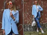 Kobieta w błękitnej marynarce i podartych jeansach prezentuje stylowe stylizacje. Okulary przeciwsłoneczne dodają charakteru.