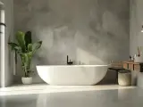 Bagno moderno con vasca freestanding e lavabo sospeso. Le pareti effetto resina creano un'atmosfera zen.