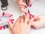 Manicure w czerwonym kolorze, idealny sposób na to, jak zapuścić paznokcie po obgryzaniu. Paleta kolorów lakierów do paznokci.