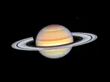 Saturn w Byku, majestatyczny gazowy olbrzym z pierścieniami, unoszący się w kosmicznej pustce.