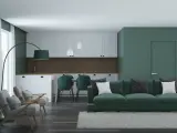 Nowoczesny salon z kuchnią w odcieniach zieleni. Seledynowy kolor ścian i mebli tworzy spokojną atmosferę.