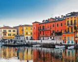Colorate case affacciate sull'acqua, un invito a scoprire le città da visitare nel nord Italia.