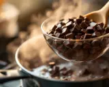 Chocolat en morceaux dans un bol au-dessus d'une casserole d'eau frémissante pour un bain-marie. Le chocolat est sur le point de fondre, prêt à être utilisé pour une recette.