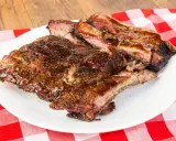 Soczyste, glazurowane żeberka BBQ na białym talerzu, idealne do jedzenia rękami. Pyszny sposób, jak jesc żeberka.