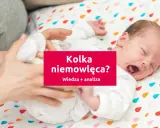 Płacz noworodka, który może wskazywać na kolkę niemowlęcą. Rodzic próbuje uspokoić dziecko.