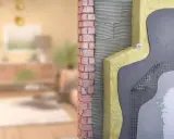 Corte de pared que muestra el aislamiento y la mampostería, parte de un sistema passivhaus para eficiencia energética.