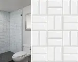Modern bathroom with shower and toilet, showcasing creative formas de colocar azulejos rectangulares grandes en un patrón de espiga y ladrillo.