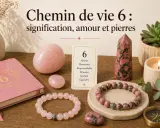 Ambiance zen avec des pierres roses, un carnet et une carte "Chemin de vie 6". La symbolique du 6 est explorée à travers l'amour, l'harmonie et le soutien.