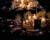 Une élégante mise de table à la française, illuminée par des bougies et des fleurs délicates, promet une soirée mémorable.