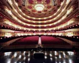 Der prunkvolle Innenraum des Gran Teatre del Liceu mit roten Samtsitzen und goldenen Verzierungen.