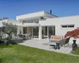 Maison moderne avec extension, terrasse aménagée. L'extension maison architecte obligatoire a créé un espace de vie lumineux et spacieux.