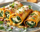 Cannelloni ricotta épinard, généreusement garnis et saupoudrés de parmesan, baignent dans une sauce savoureuse.