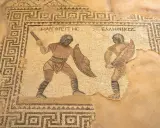 Antikes Mosaik zeigt zwei Gladiatoren im Kampf, eine Szene aus dem römischen Reich.