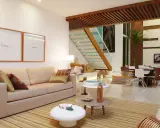 Elegantes salones marrones y beige con sofá, mesas auxiliares, alfombra a rayas y una escalera moderna.