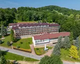 Sanatoria pełnopłatne w Iwoniczu-Zdroju: rozległy kompleks budynków otoczony zielenią, z widocznym napisem "Sanatorium Górnik".