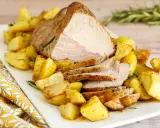 Arrosto di vitello al forno, succulento e dorato, servito con patate arrosto croccanti e profumate al rosmarino.