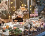 Mesa dulce con variedad de postres, incluyendo un candy bar rústico con chocolates y galletas.