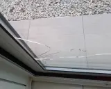 Vitrage fissuré, probablement suite à un choc thermique. Des éclats de verre traversent la surface.