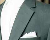 A close-up of a teal suit jacket shows the lapel and a crisp white pocket square.