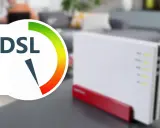 DSL-Router mit Anzeige für 16 mbit/s Geschwindigkeit. Im Hintergrund ein Wohnzimmer.