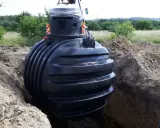 Montaż podziemnego zbiornika na deszczówkę, kluczowego elementu do odprowadzenia wody z rynien.