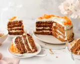 Delicioso pastel de zanahoria con glaseado cremoso y decoraciones de zanahoria. Varias porciones listas para disfrutar.