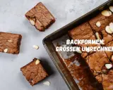 Saftige amerikanische Masse Brownies, frisch aus der Form geschnitten, mit Mandelsplittern verziert.