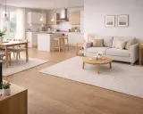 Ett ljust och modernt vardagsrum med kök. Två mattor i samma rum skapar en ombonad känsla.