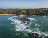 Malownicze wybrzeże, gdzie leży Sri Lanka. Tropikalna roślinność, plaże i skaliste wysepki w turkusowej wodzie.