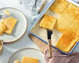 Goldbraune Pfannkuchen vom Blech, frisch aus dem Ofen, werden mit Apfelmus serviert. Ein Genuss für die ganze Familie!