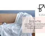 Biały, błyszczący koc na kanapie. Dowiedz się, na jakim programie prać koce, by zachowały miękkość.