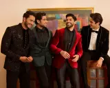 Four men in stylish winter wedding attire, showcasing embellished jackets in black, green, red, and velvet.