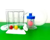 A breathing trainer with three chambers and colored balls for measuring lung capacity, and a separate device with a pink ball for **atmen gegen widerstand**.