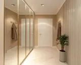 Elegancki przedpokój inspiracje ściany: lustrzana szafa, sztukateria i subtelne oświetlenie tworzą przytulną przestrzeń.